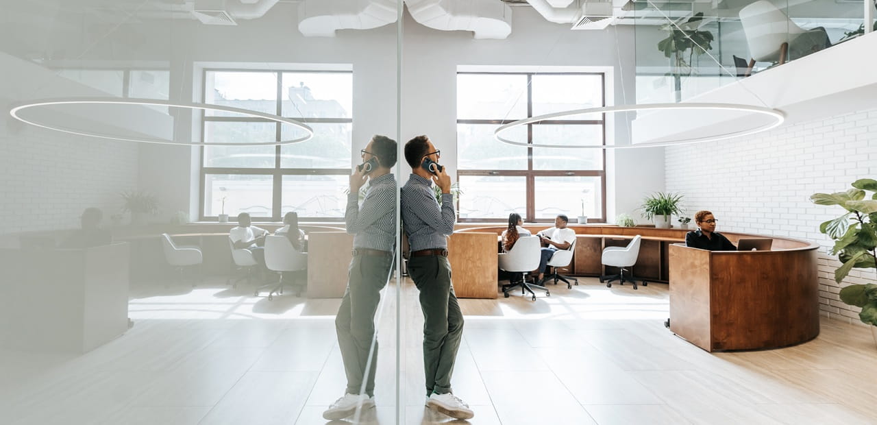 Business owner on phone in modern offiice, illustrating life insurance as a tool for business protection and continuity.
