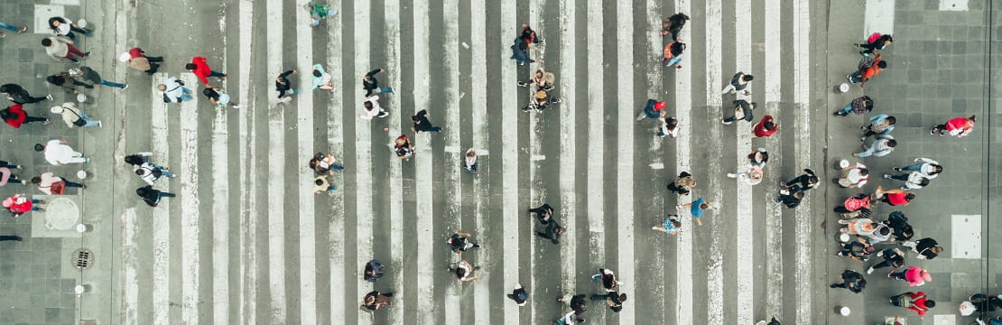 Aerial view of crowd crossing a crosswalk
